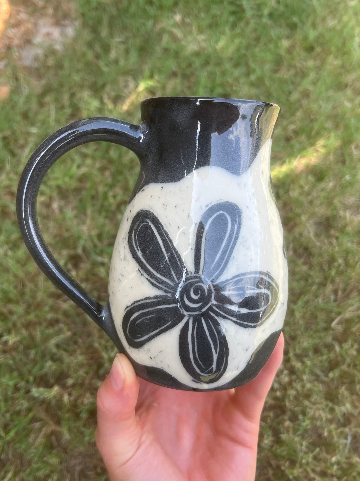 Black sgraffito flower mug