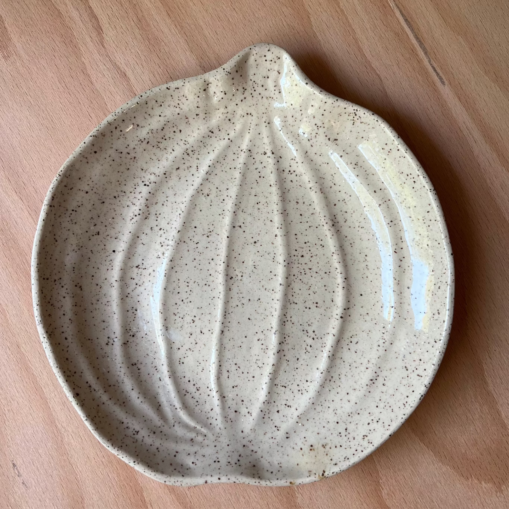 Speckled pumpkin ceramic dish on a wooden surface