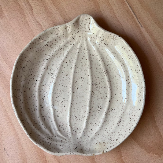 Speckled pumpkin ceramic dish on a wooden surface